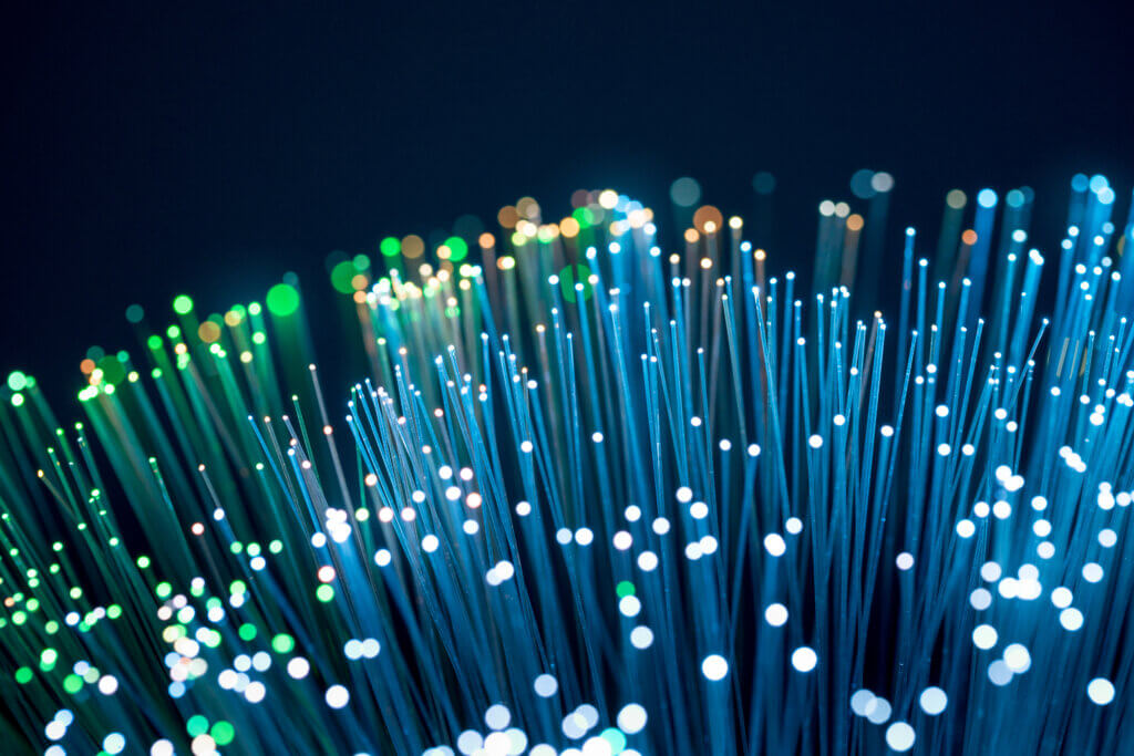 Dalton, Georgia (DNN3) A close-up of fiber optic cables emitting bright lights, illustrating advanced networking and data transmission technologies.